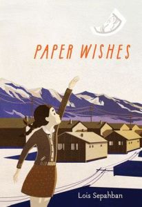 Paper wishes young girl reaching out mountains behind row of houses paper flying off