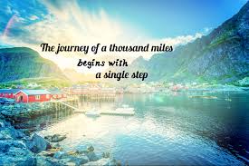 The journey of a thousand miles begins with a single step quote on background of mountain and lake blue sky