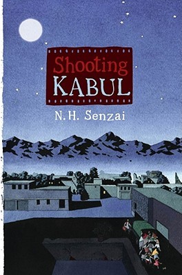 Shooting Kabul letters inside photo negative strip N. H. Senzai underneath night sky behind large moon small buildings in foreground with people behind a truck