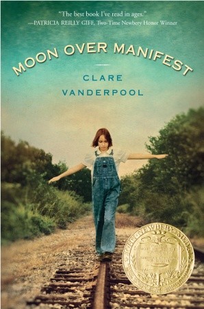 light blue-green sky with girl walking on rail tracks with arms outstretched wearing denim dungarees. bushes beside tracks. Moon over Manifest in arch over top in white letters and Clare Vanderpool in blue letters underneath. yellow seal of Newbery medal in bottom right corner.