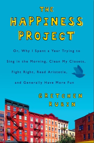 blue cover with image of red and brown apartment blocks at bottom. The Happiness Project in yellow letters across top and Gretchen Rubin in yellow just above buildings. blue bird flying towards words in blue in middle.