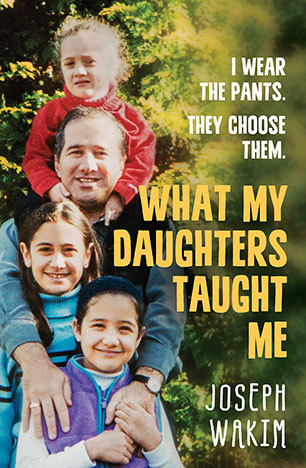 cover image of man holding two girls in front of him and another smaller girl on his shoulders posing for camera with smiles. green tree behind them. yellow letters down right side read 'What my daughters taught me.'