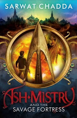 large golden ring in middle with arrowhead inside and boy looking at evil person. fortress like structure in background at top in darkening sky. blue at base with red letters reading Ash Mistry and the Savage Fortress.