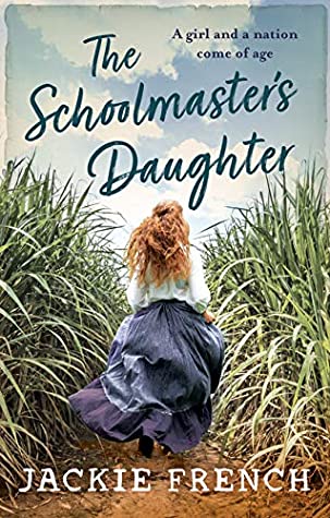 cover image looks like photograph. young lady in long flowing blue skirt and white blouse with long brown hair running through wild green grass with blue sky above. dark letters across top part read The Schoolmaster's Daughter and along bottom white letters read Jackie French.
