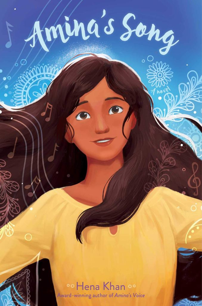 Indian girl in yellow blouse and dark brown hair with blue background with patterns. light blue-white letters above her reads Amina's Song.
