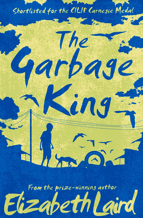cover image in silhouette. green background while image in blue. image of boy with dog, electricity wires running to a pole. birds flying above. blue letters in green sky reads The Garbage King. green letters on blue at bottom reads Elizabeth Laird.