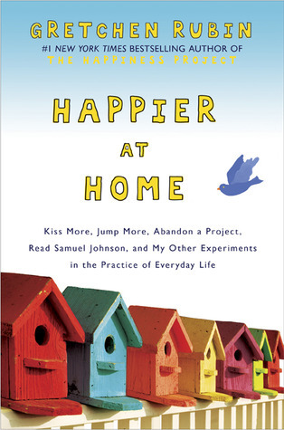 cover image of small mulit-coloured bird boxes on top of yellow fence. blue-ish background with cartoon-y bird at right. yellow letters in middle reads Happier at Home with Gretchen Rubin at top edge.
