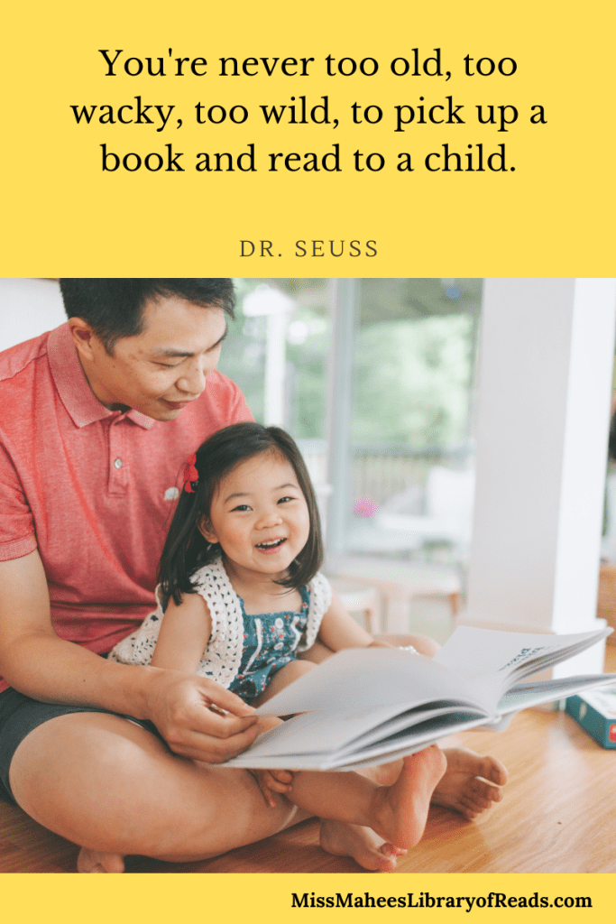 image of Asian dad in red shirt seated with cute little daughter in white and blue dress reading book on wooden floor. yellow background. quote above reads 'You're never too old, too wacky, too wild, to pick up a book and read to a child. Dr Seuss.'