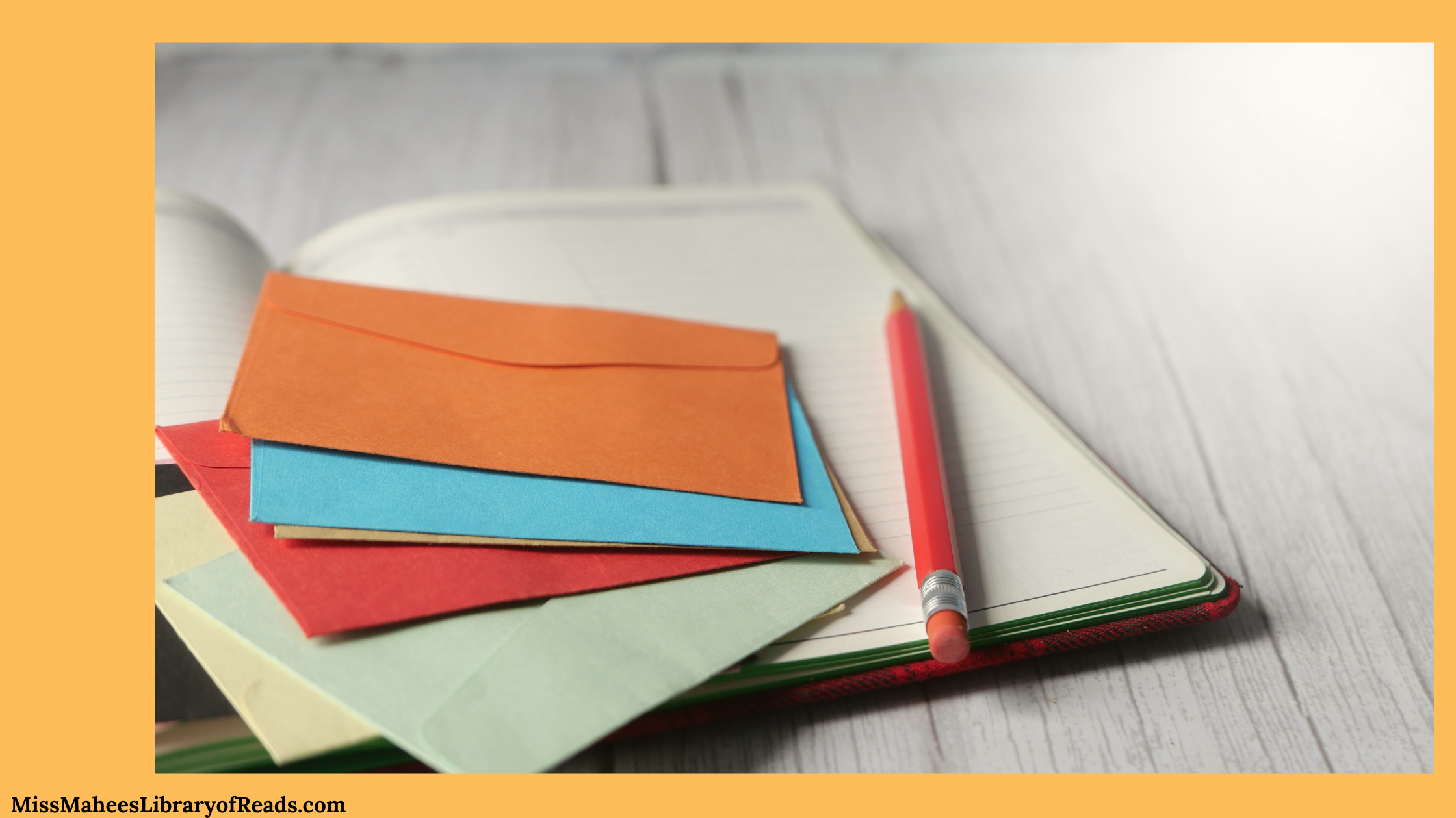 image over most of banner of coloured envelopes laying on top of open book with red pencil right of them. book is on wooden table. orange background.