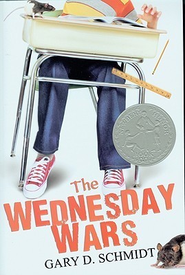 cover image has kid in jeans sitting at school desk. only jeans and red and white sneaker visible. one hand and little bit of striped shirt visible. small guinea pig in bottom right hand corner. white background. large orange letters across bottom slightly slanted reads The Wednesday Wars and in small black ones beneath that Gary D. Schmidt.
