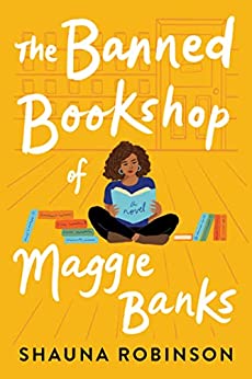 cover image has African American woman sitting on yellow floor with blue book in hand and some books beside her. background looks like interior of shop in yellow. large white letters above and below her reads The Banned Bookshop of Maggie Banks. smaller black letters reads Shauna Robinson along bottom edge.
