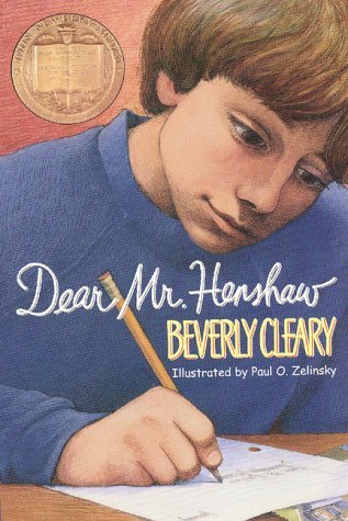 image of boy in blue sweater holding pencil in right hand writing on paper on table. boy has light brown hair and looks serious. pink-orange background. image of award in top left corner behind boy. middle of blue sweater cursive white letters reads Dear Mr. Henshaw and yellow capital letters below reads Beverly Cleary and smaller white ones below this reads Illustrated by Paul O. Zelinsky