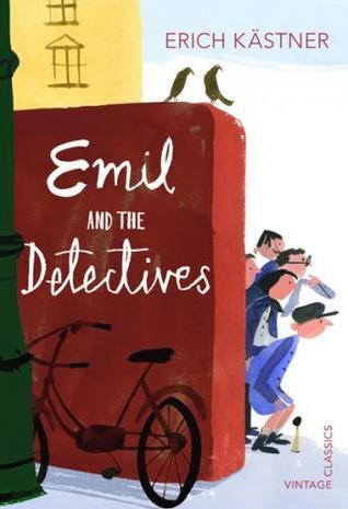 cartoon-style image. group of boys looking out behind red. white large letters on wall in front reads Emil and the Detectives with black bicycle below it and green lamp post to left edge. yellow building behind with blue and white sky in background. red letters on top right edge reads Erich Kastner and Vintage Classics on bottom right.