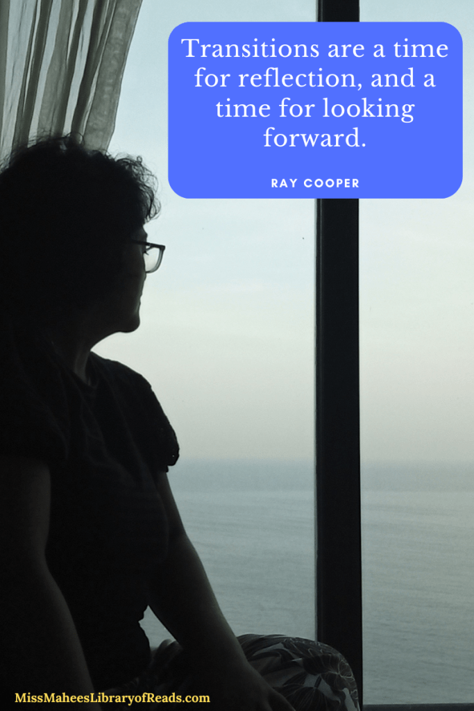 author seated by window looking out at sea in background and lighter sky above. grey curtain behind her. author in shadow. small quote inside blue box with rounded edges reading 'Transitions are a time for reflection, and a time for looking forward. Ray Cooper'. letter in white. small yellow letters at bottom left reads MissMaheesLibraryofReads.com